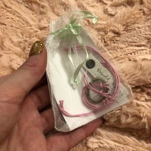 Pink Rope Bracelet with "strength" written on it